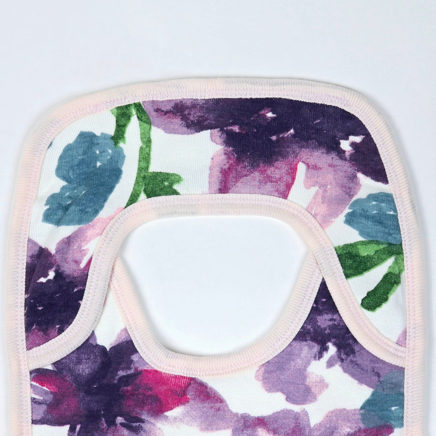 Burt's Bees Baby bib with a watercolor floral design